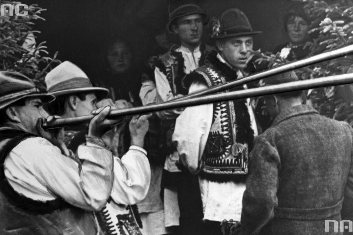 Hutsul musicians playing long wooden trembita horns in the Carpathians.