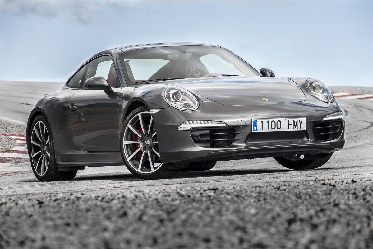 A classic Porsche 911 sports car with round headlights and a sloping roof.