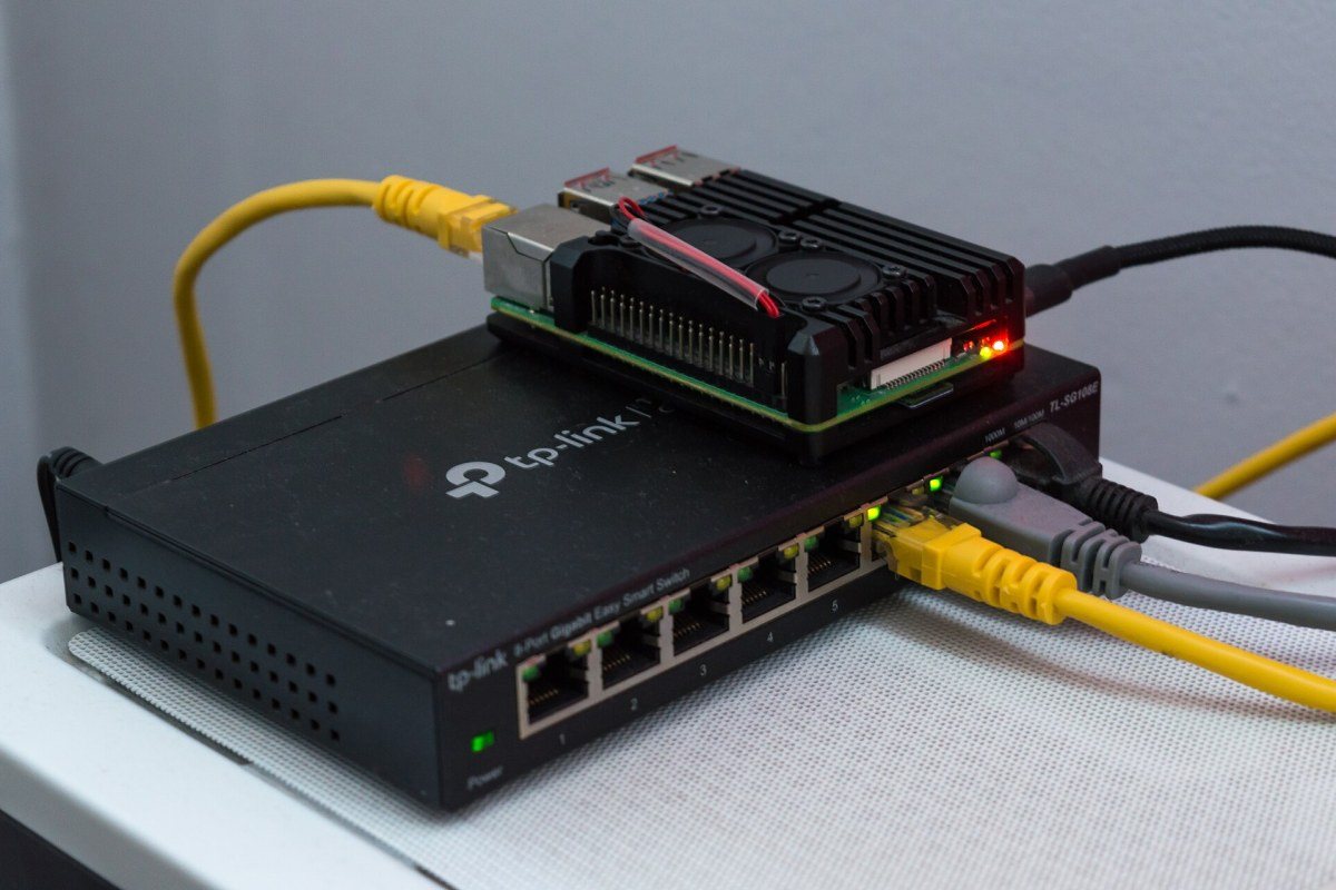 A network switch with many ethernet cables plugged into its ports.
