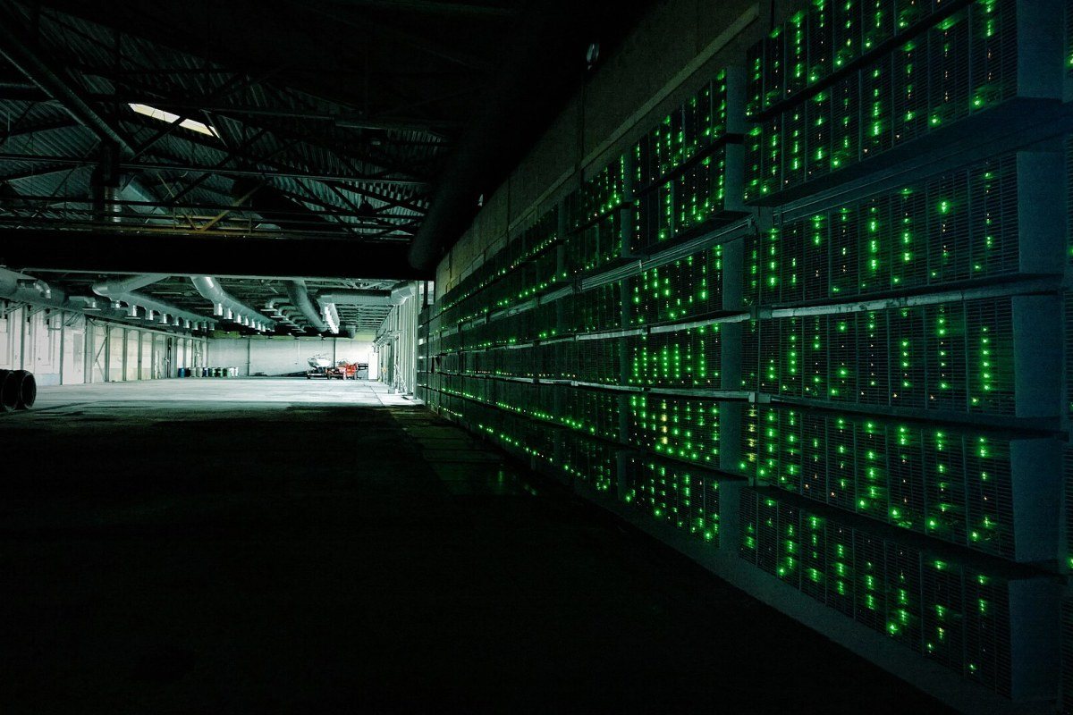 Rows of specialised computers used for cryptocurrency mining on a blockchain network.