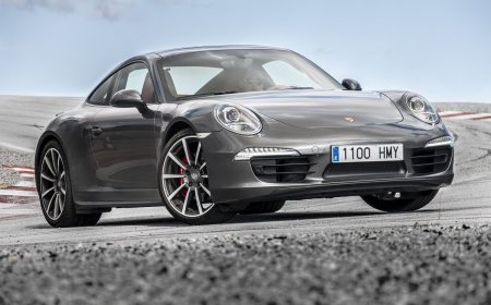 A classic Porsche 911 sports car with round headlights and a sloping roof.