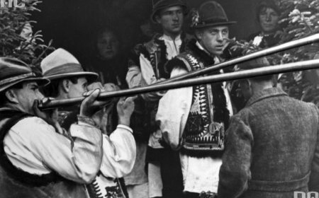 Hutsul musicians playing long wooden trembita horns in the Carpathians.